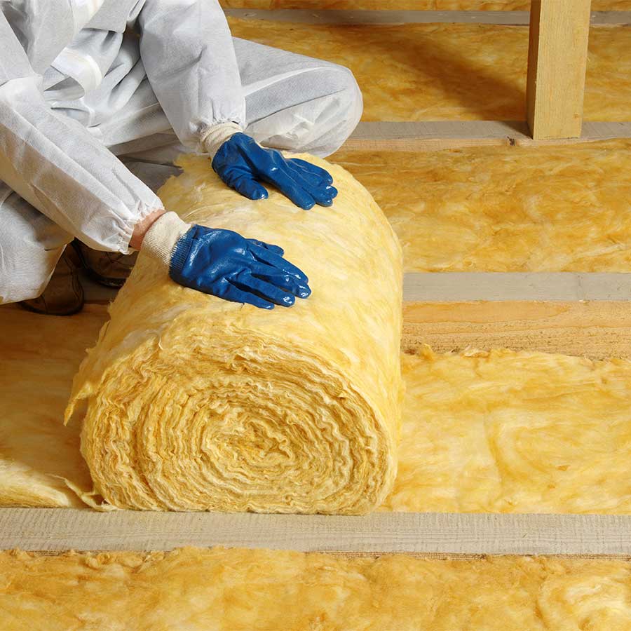 modern high efficiency firbre loft insulation being installed in an attic