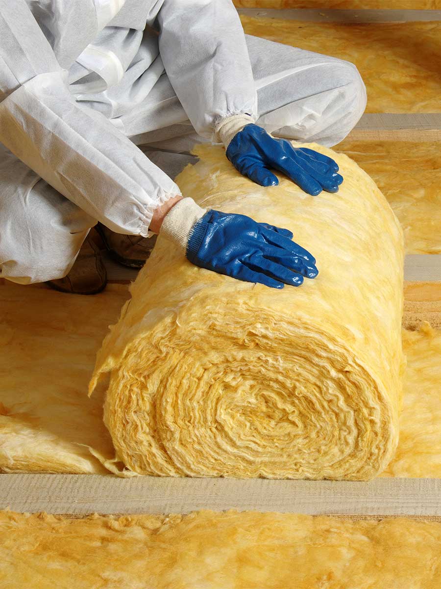 loft insulation installers fitting modern fibre insulation rolls in a domestic loft