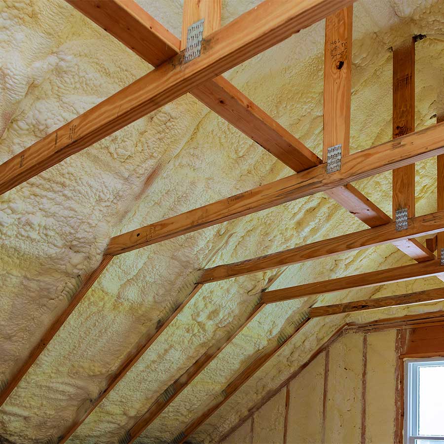 Spray foam insulation covering the timbers in a domestic home loft